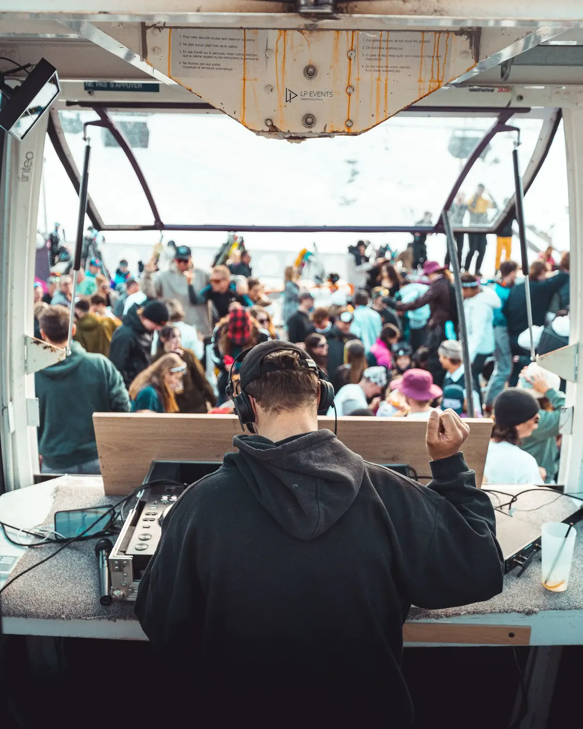 DJ playing to a packed crowd at a mountain bar
