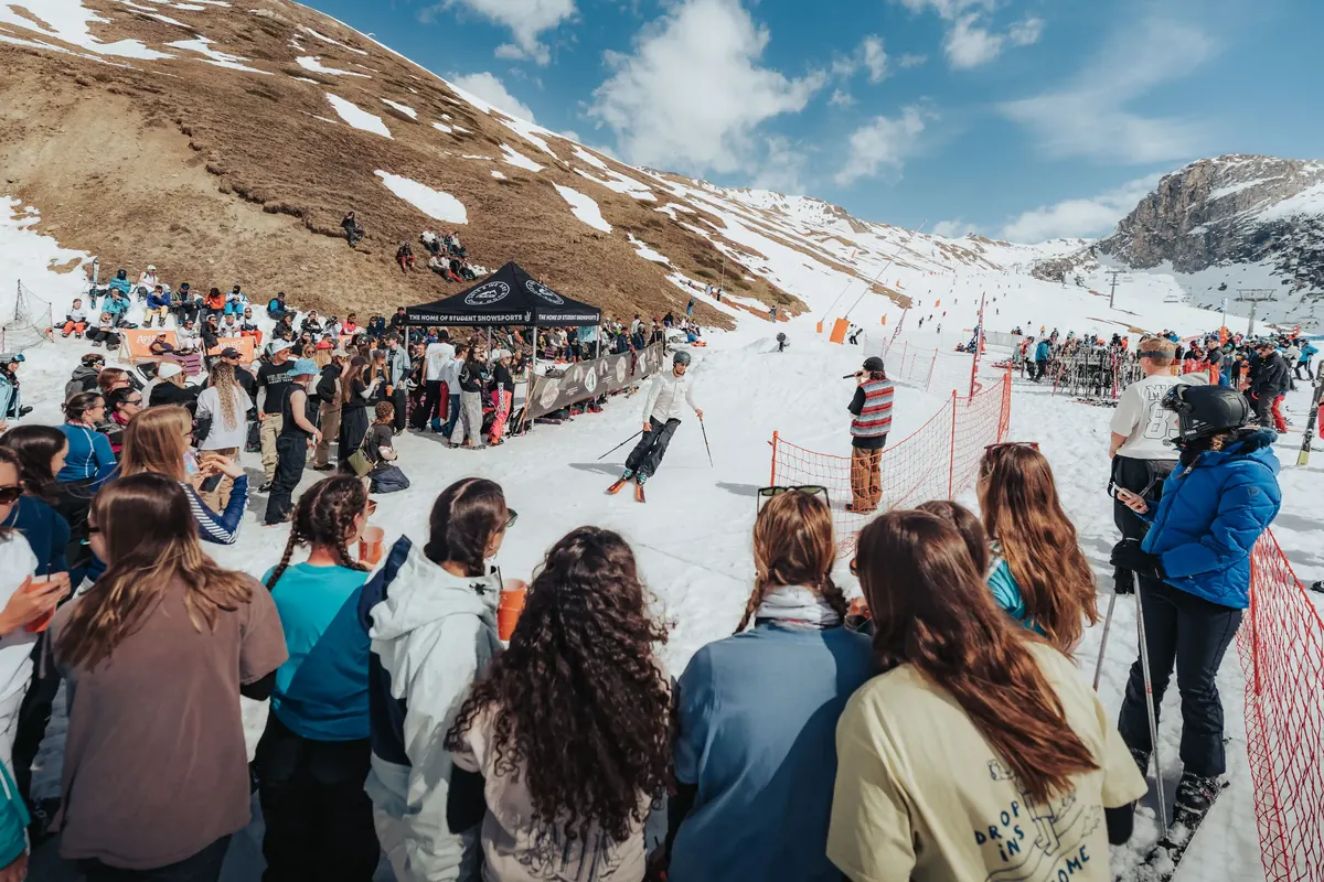 Students gathered at an outdoor apres bar at the foot of the slopes