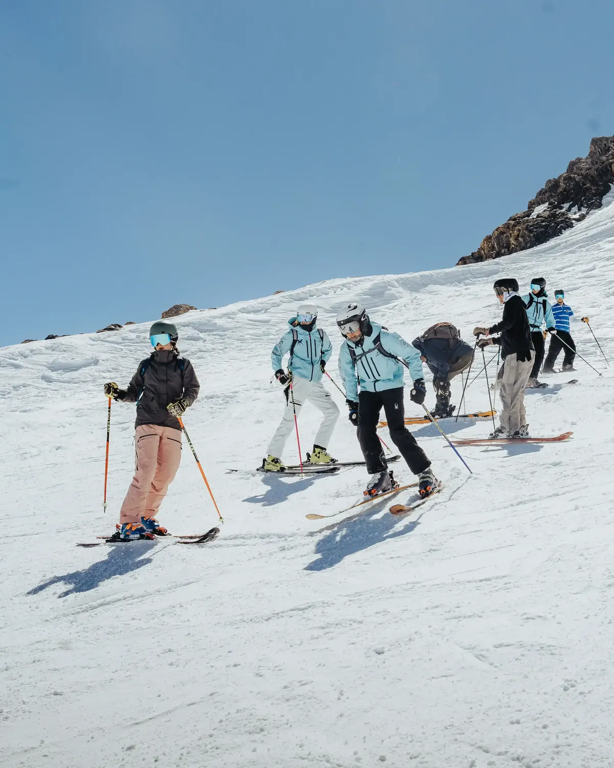 Group of SSX members skiing together down a wide open slope